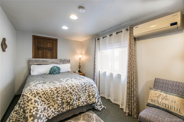 bedroom featuring dark carpet and a wall unit AC