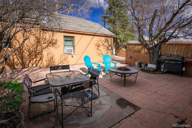 view of patio featuring a fire pit, grilling area, and cooling unit