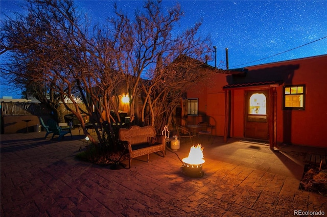 exterior space featuring an outdoor fire pit