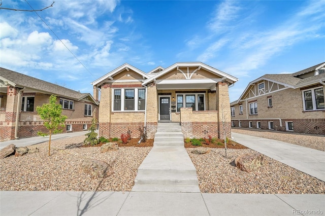 view of front of property featuring a porch and brick siding
