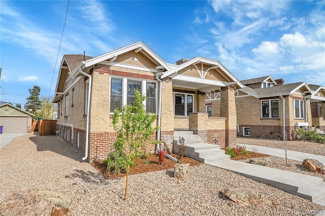 view of front of home with covered porch and brick siding