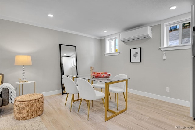 dining area featuring recessed lighting, baseboards, light wood-type flooring, and a wall mounted air conditioner