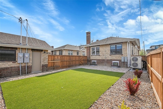 view of yard with a patio, ac unit, and a fenced backyard