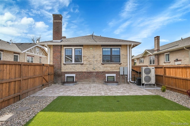 back of property featuring a lawn, a fenced backyard, and a patio area