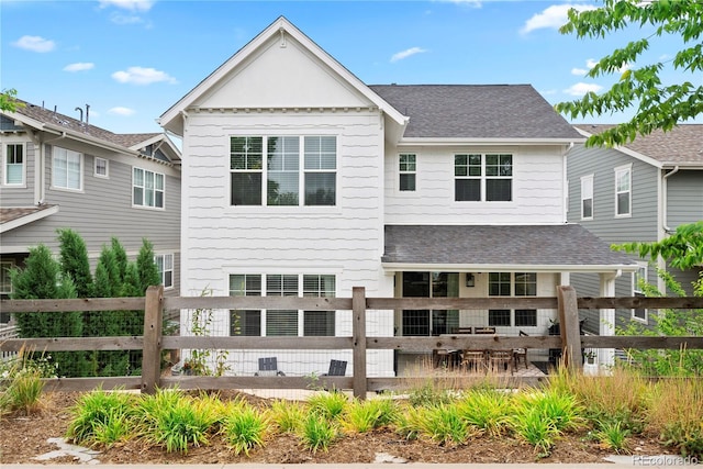 2027 Vallejo Loop, Broomfield, CO 80023 - rear view of house with a shingled roof and fence