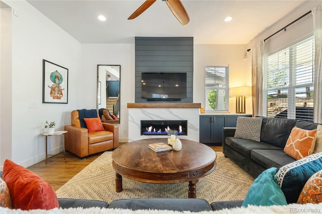 2027 Vallejo Loop, Broomfield, CO 80023 - living room featuring light wood-style floors, ceiling fan, a high end fireplace, recessed lighting, and baseboards