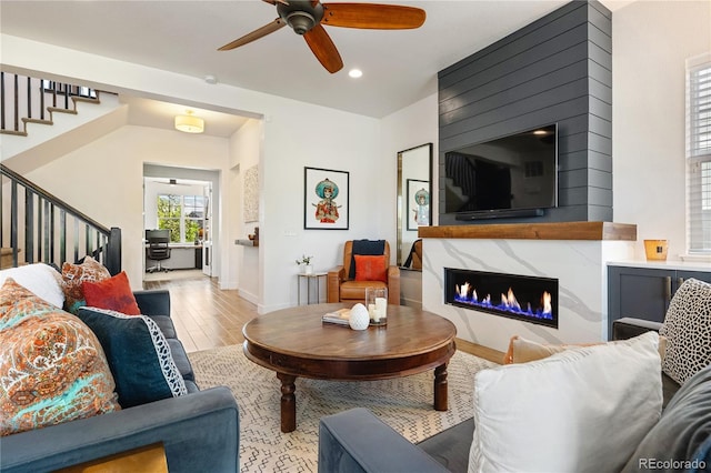 2027 Vallejo Loop, Broomfield, CO 80023 - living area featuring stairs, wood finished floors, a fireplace, a ceiling fan, and recessed lighting