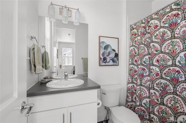 2027 Vallejo Loop, Broomfield, CO 80023 - bathroom featuring toilet, vanity, and a shower with shower curtain