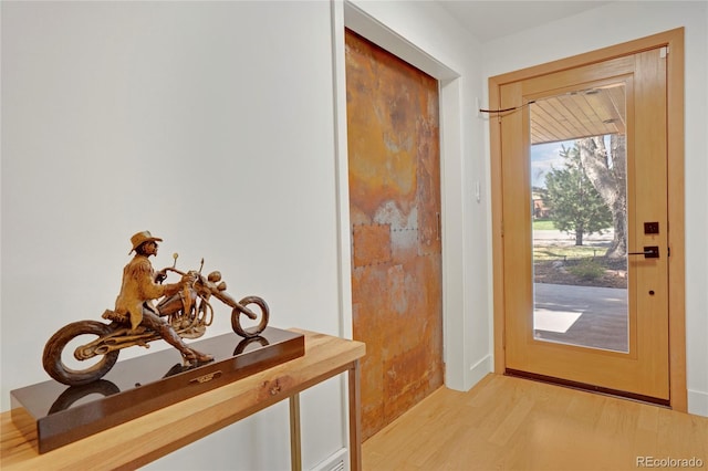 doorway to outside with light wood-style floors