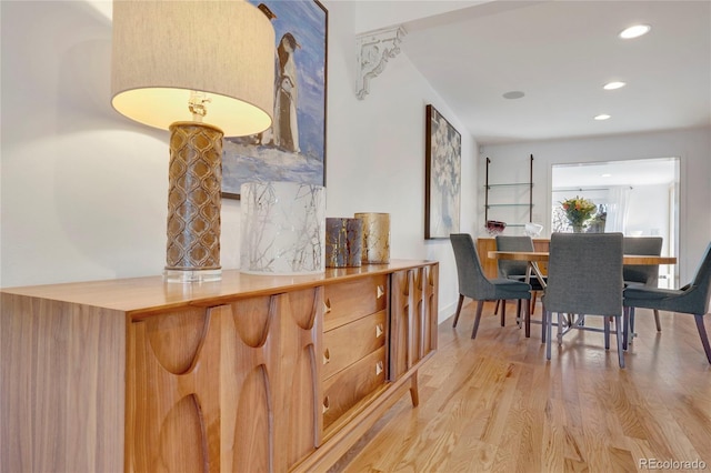 dining space with light wood-type flooring and recessed lighting