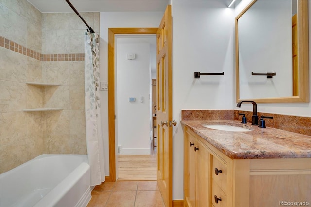 bathroom with shower / bath combo, tile patterned flooring, vanity, and baseboards
