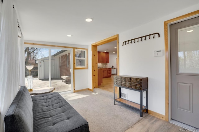 interior space featuring light wood-style flooring, baseboards, and recessed lighting