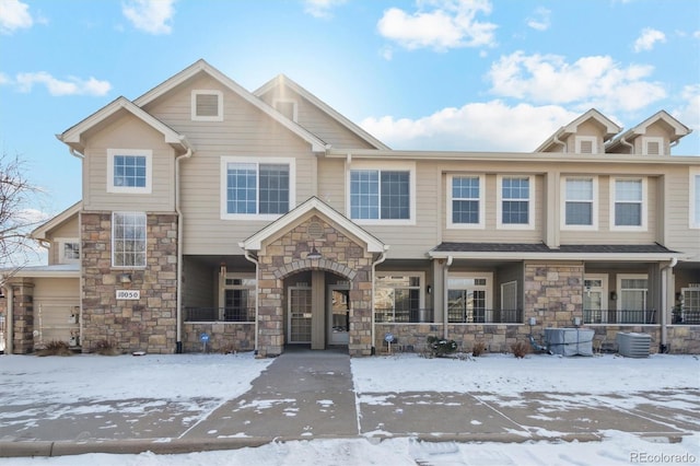 multi unit property featuring stone siding and central AC unit