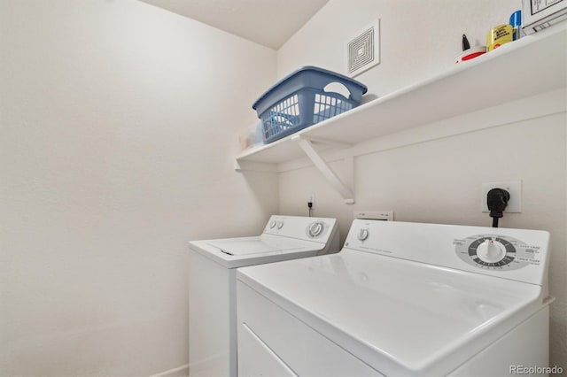 clothes washing area featuring laundry area, separate washer and dryer, and visible vents