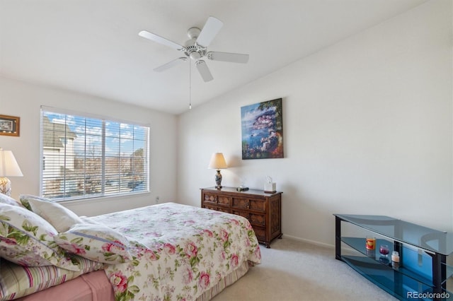 bedroom with light carpet, ceiling fan, and baseboards