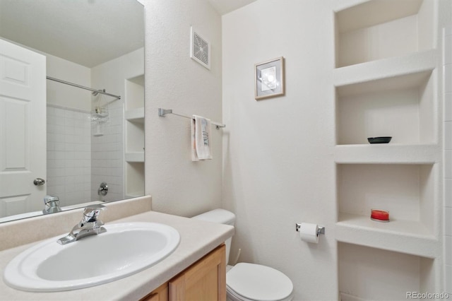 bathroom with visible vents, toilet, walk in shower, vanity, and built in shelves