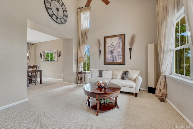 5625 S Buchanan St, Aurora, CO 80016 - carpeted living area featuring a high ceiling, ceiling fan, and baseboards