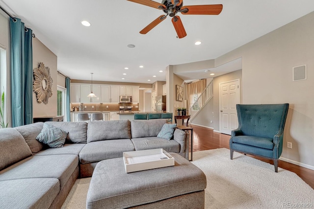 5625 S Buchanan St, Aurora, CO 80016 - living room featuring wood finished floors, ceiling fan, stairway, recessed lighting, and baseboards