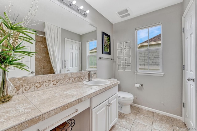 5625 S Buchanan St, Aurora, CO 80016 - bathroom featuring vanity, toilet, baseboards, and tile patterned flooring