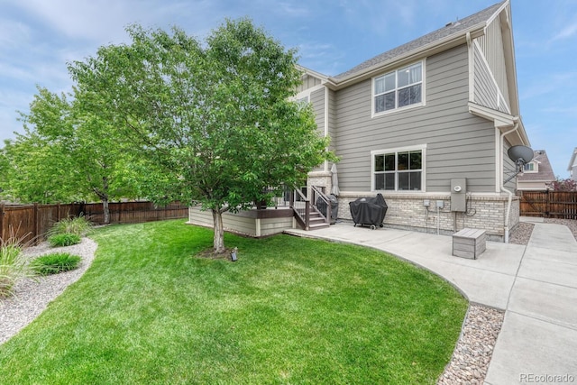 5625 S Buchanan St, Aurora, CO 80016 - back of property with a patio, brick siding, and a wooden deck