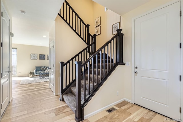 foyer entrance with light wood-type flooring