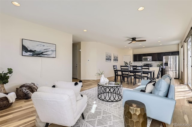 living area with light wood finished floors, a ceiling fan, and recessed lighting