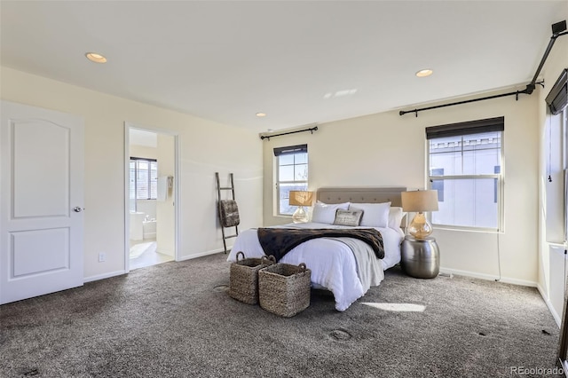 carpeted bedroom with multiple windows and ensuite bath