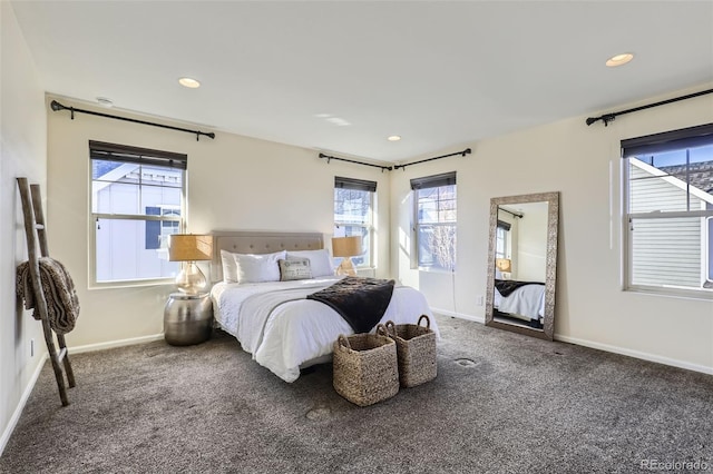 bedroom featuring dark colored carpet, recessed lighting, and baseboards