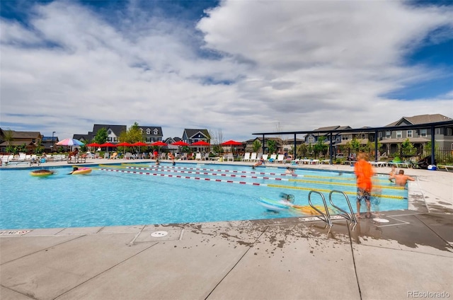 view of pool with a residential view