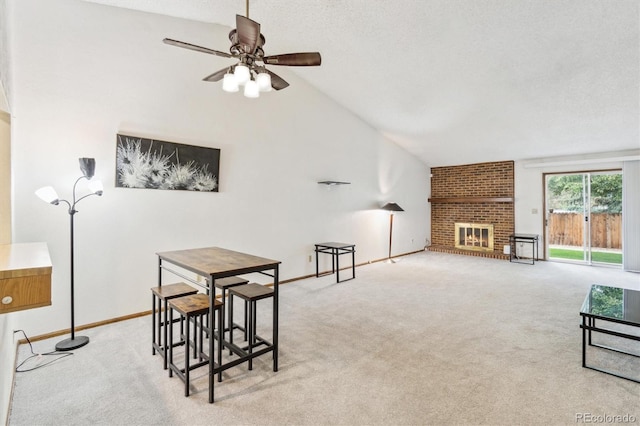 14333 E Warren Pl, Aurora, CO 80014 - dining room featuring vaulted ceiling, carpet flooring, ceiling fan, a brick fireplace, and baseboards