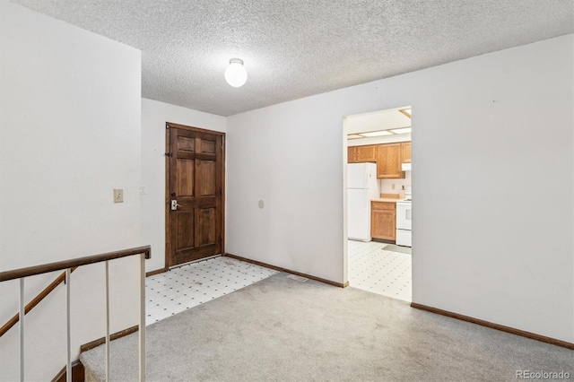 14333 E Warren Pl, Aurora, CO 80014 - empty room featuring baseboards, a textured ceiling, and light carpet