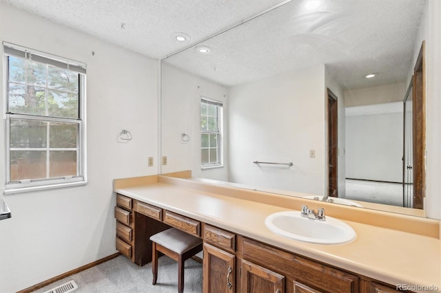 14333 E Warren Pl, Aurora, CO 80014 - bathroom with vanity, a textured ceiling, recessed lighting, and baseboards