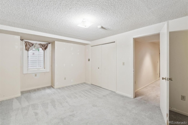 14333 E Warren Pl, Aurora, CO 80014 - unfurnished bedroom with a textured ceiling, light colored carpet, a closet, and baseboards