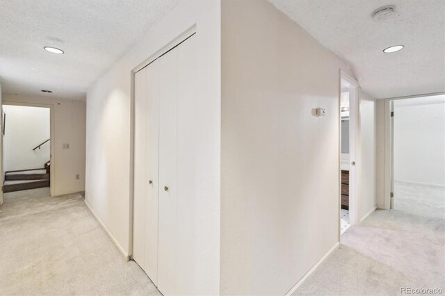 14333 E Warren Pl, Aurora, CO 80014 - hall featuring light colored carpet, a textured ceiling, baseboards, stairs, and recessed lighting