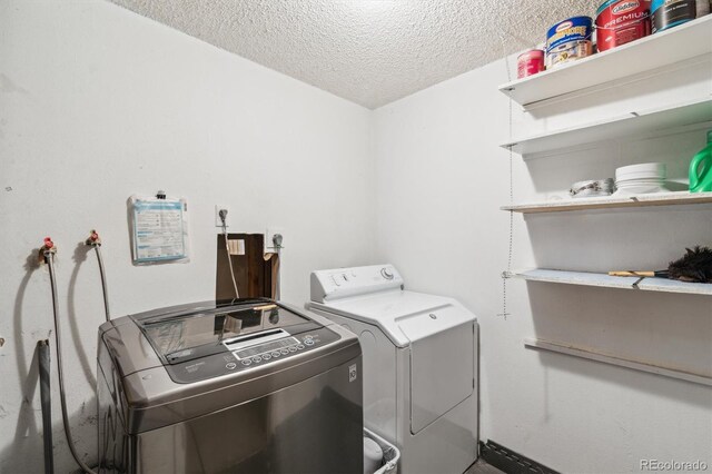 14333 E Warren Pl, Aurora, CO 80014 - washroom with washer and dryer and a textured ceiling