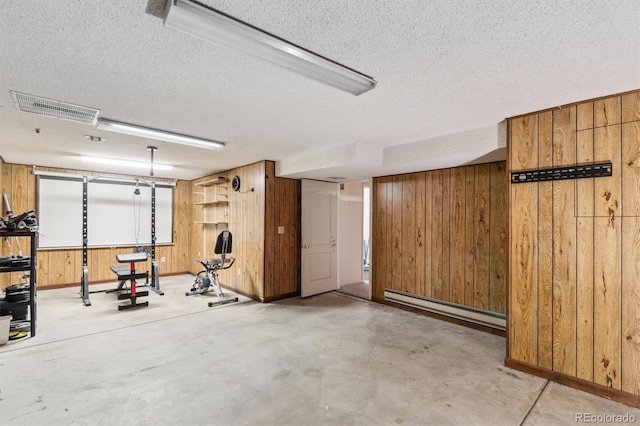 14333 E Warren Pl, Aurora, CO 80014 - garage featuring a baseboard radiator, wooden walls, and baseboards