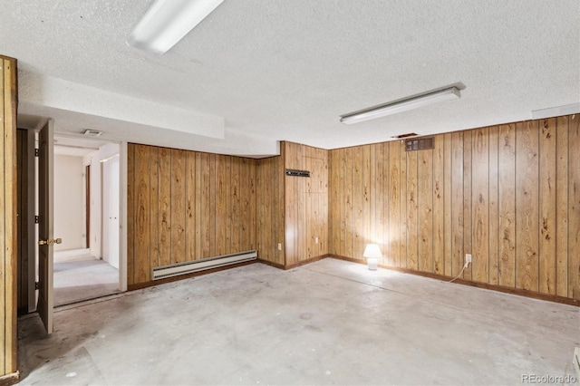 14333 E Warren Pl, Aurora, CO 80014 - spare room featuring baseboard heating, concrete floors, wood walls, a textured ceiling, and baseboards