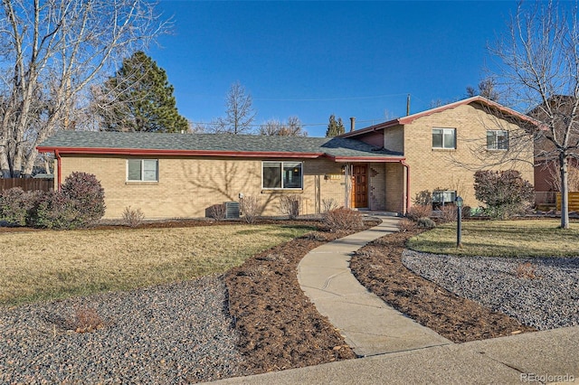 view of front facade with a front lawn and central AC unit