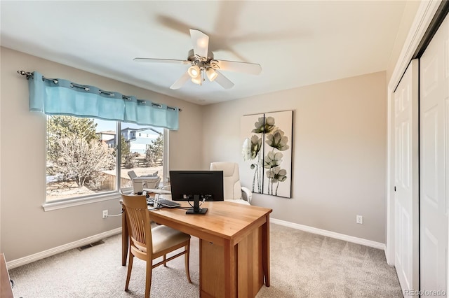 office area with light colored carpet, visible vents, and baseboards