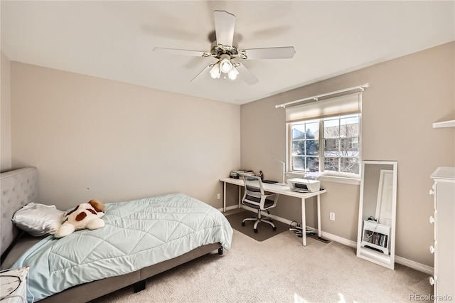 carpeted bedroom with ceiling fan and baseboards