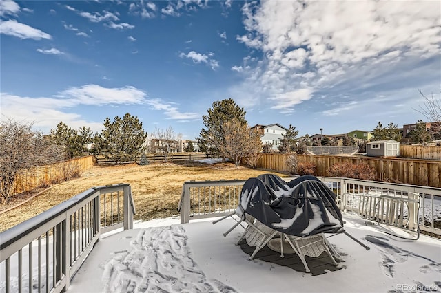 view of patio / terrace with a fenced backyard, an outdoor structure, and a wooden deck