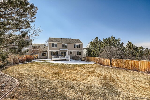 rear view of property featuring a patio, a lawn, and a fenced backyard