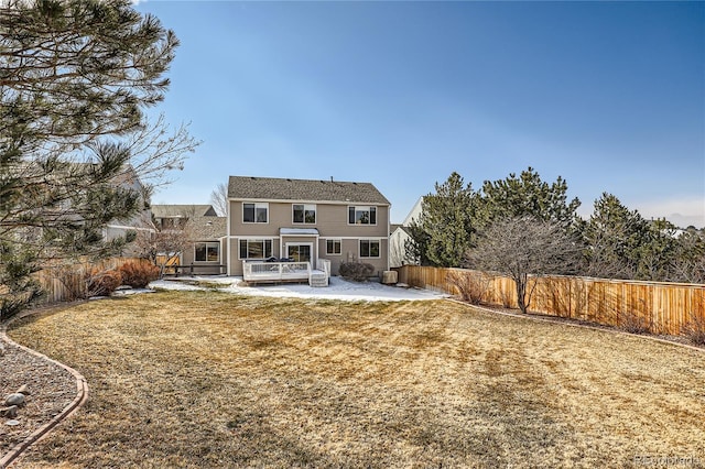 back of property with a patio, a fenced backyard, and a lawn