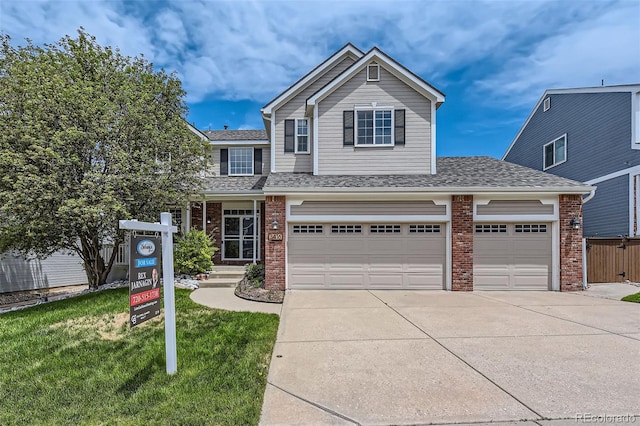 3416 Hawthorne Dr, Highlands Ranch, CO 80126 - view of front of house with brick siding, driveway, a front lawn, and a shingled roof