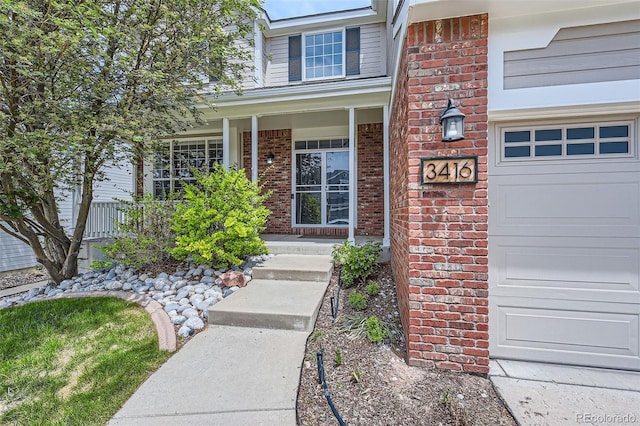 3416 Hawthorne Dr, Highlands Ranch, CO 80126 - doorway to property with brick siding, covered porch, and an attached garage