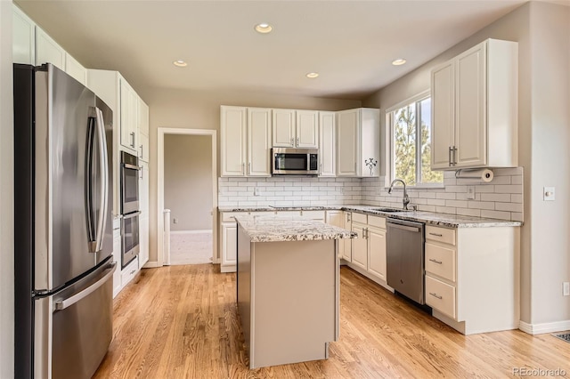 3416 Hawthorne Dr, Highlands Ranch, CO 80126 - kitchen featuring stainless steel appliances, a sink, a center island, decorative backsplash, and recessed lighting
