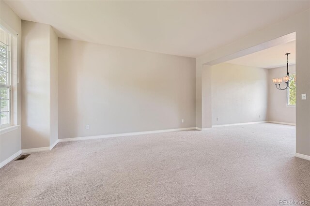 3416 Hawthorne Dr, Highlands Ranch, CO 80126 - spare room featuring a chandelier, carpet floors, plenty of natural light, and baseboards