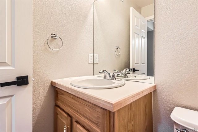 3416 Hawthorne Dr, Highlands Ranch, CO 80126 - half bath featuring vanity, toilet, and a textured wall