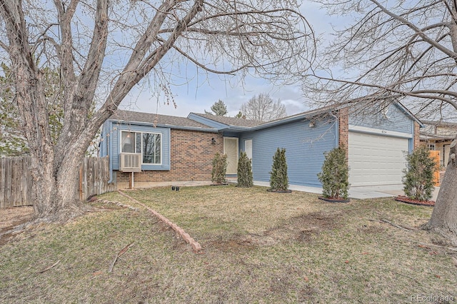 ranch-style house featuring a garage, brick siding, a front lawn, and fence