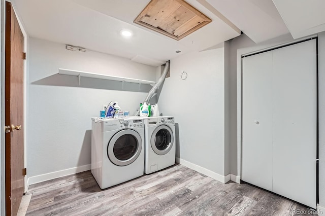 clothes washing area with laundry area, baseboards, light wood-type flooring, separate washer and dryer, and recessed lighting